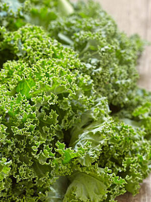 Fresh green kale leaves on wooden table