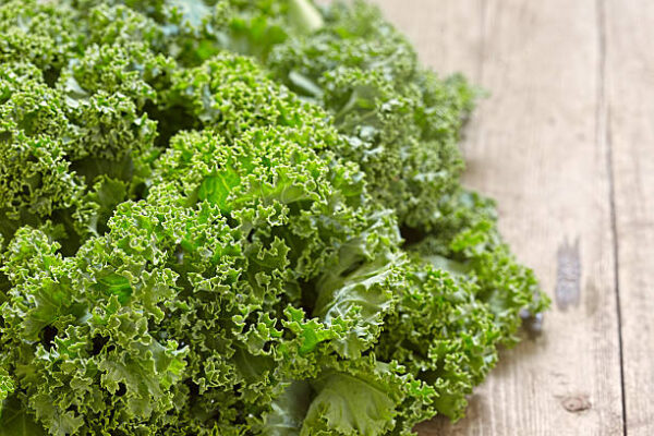 Fresh green kale leaves on wooden table
